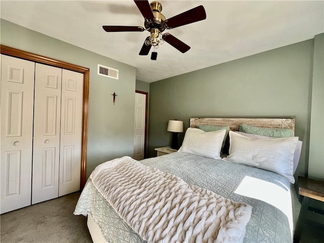 carpeted bedroom featuring a ceiling fan, visible vents, and a closet