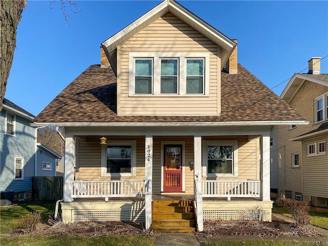 bungalow-style home featuring a porch, central air condition unit, and a shingled roof