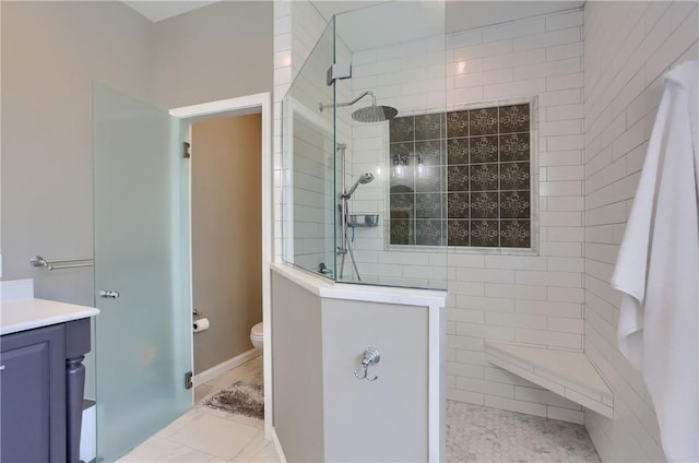 bathroom featuring toilet, vanity, and a walk in shower