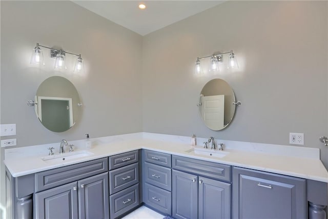 bathroom with a sink and double vanity