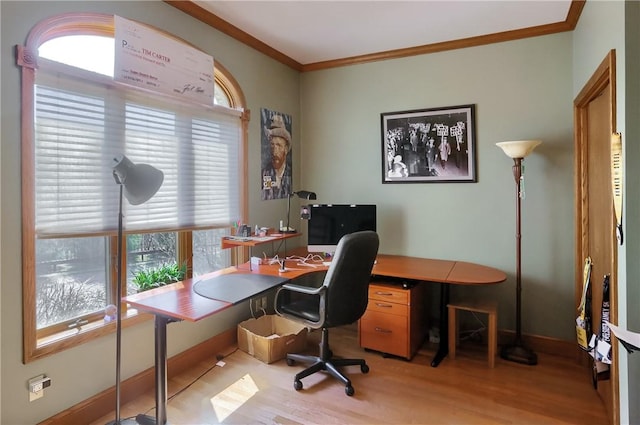 office area with light wood-style flooring, baseboards, and ornamental molding