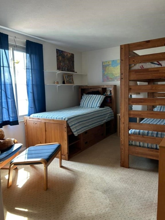 bedroom featuring light colored carpet