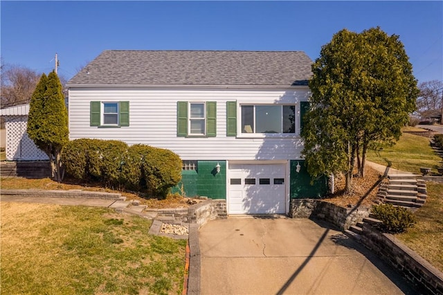 view of front of property with a shingled roof, a front lawn, concrete driveway, stairs, and an attached garage