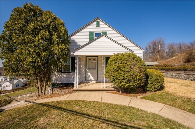 bungalow-style home with a porch and a front lawn