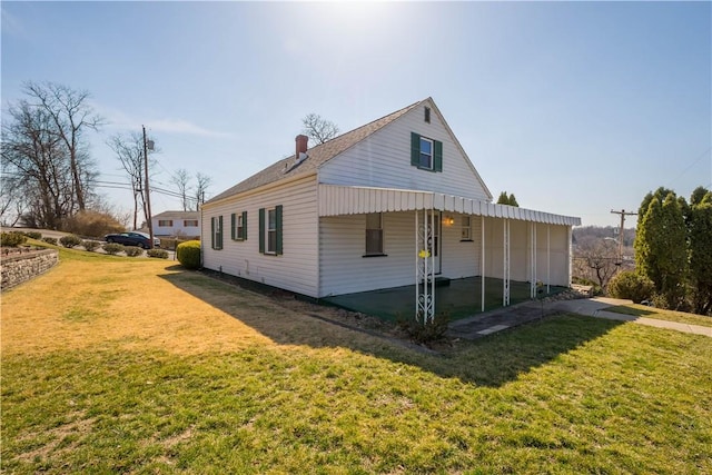 view of home's exterior with a carport and a yard