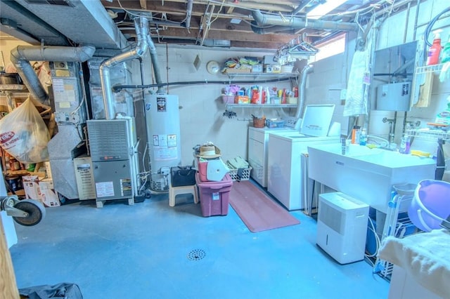 basement featuring washer and dryer and water heater