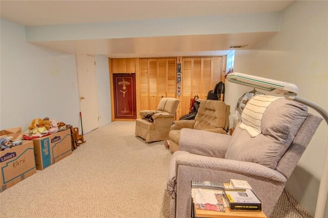 carpeted living area featuring visible vents