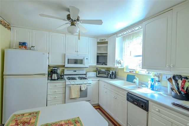 kitchen featuring white appliances, open shelves, a sink, light countertops, and white cabinets