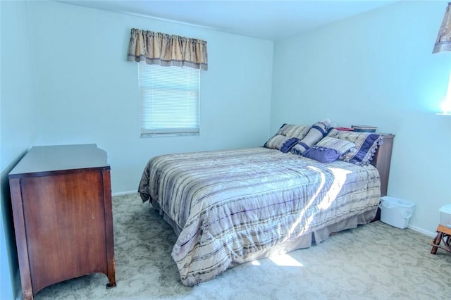 carpeted bedroom featuring baseboards