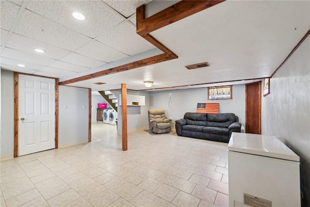 basement with visible vents, independent washer and dryer, recessed lighting, white fridge, and stairs