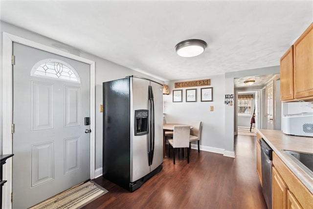 kitchen with stainless steel appliances, dark wood-type flooring, baseboards, and light countertops