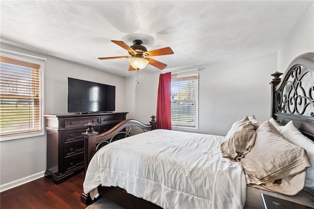 bedroom featuring baseboards, dark wood-type flooring, and ceiling fan