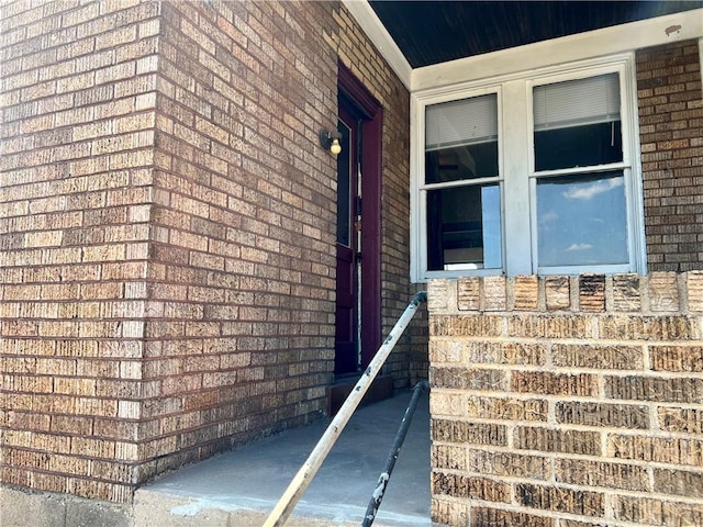 property entrance featuring brick siding