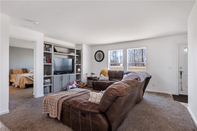 living area with visible vents, baseboards, and carpet flooring