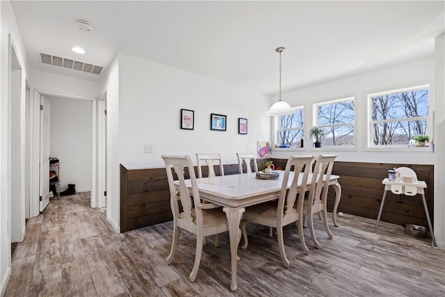 dining space with recessed lighting, wood finished floors, and visible vents