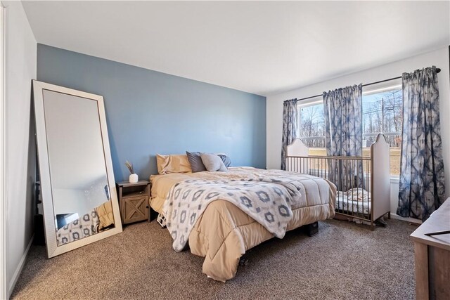 carpeted bedroom featuring baseboards