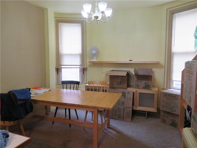 dining room with carpet floors, a notable chandelier, and a healthy amount of sunlight