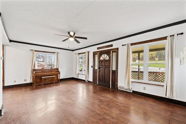 foyer entrance featuring hardwood / wood-style flooring, crown molding, a ceiling fan, and a healthy amount of sunlight