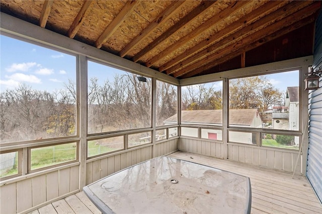 unfurnished sunroom with lofted ceiling