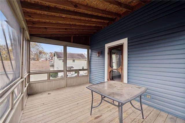 unfurnished sunroom with wood ceiling and vaulted ceiling with beams