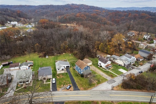 bird's eye view featuring a forest view and a residential view