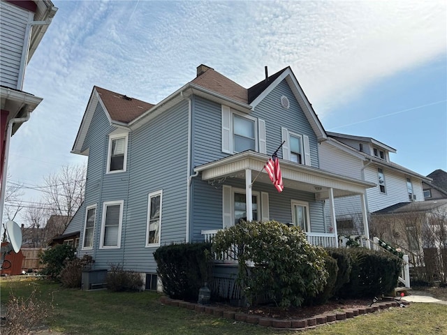 view of property exterior with a lawn and a porch