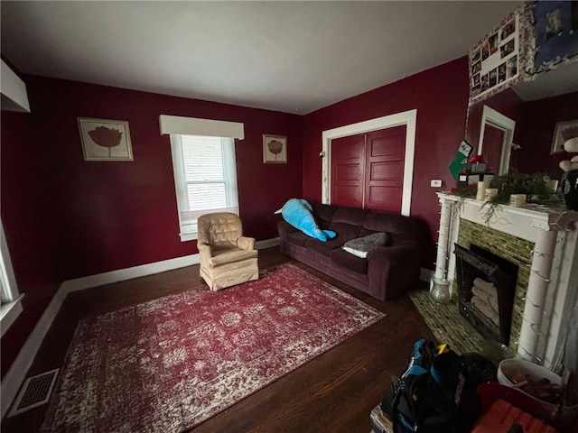319 Cedar Ave, Sharon, PA 16146 - living area featuring wood finished floors, visible vents, baseboards, and a fireplace with raised hearth