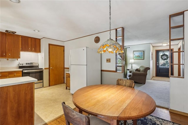 dining space featuring light colored carpet and light wood finished floors