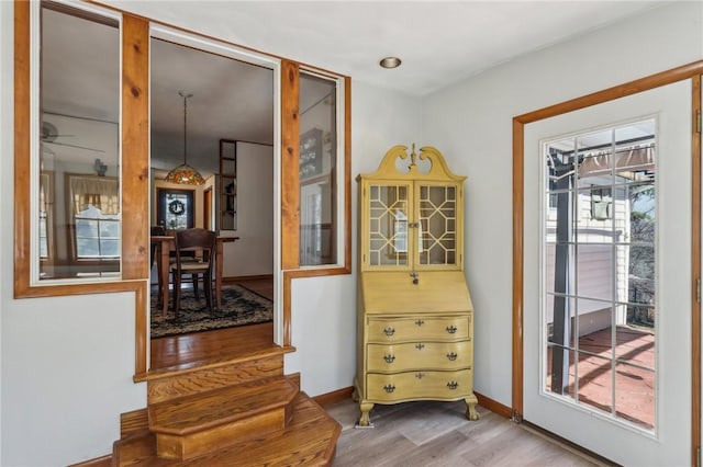 interior space featuring baseboards and wood finished floors