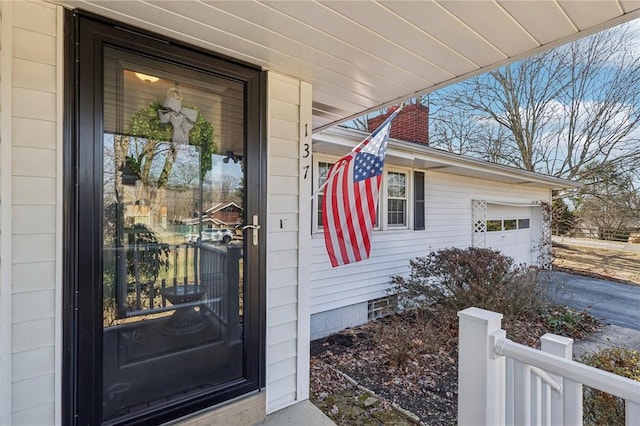 property entrance with an attached garage and crawl space