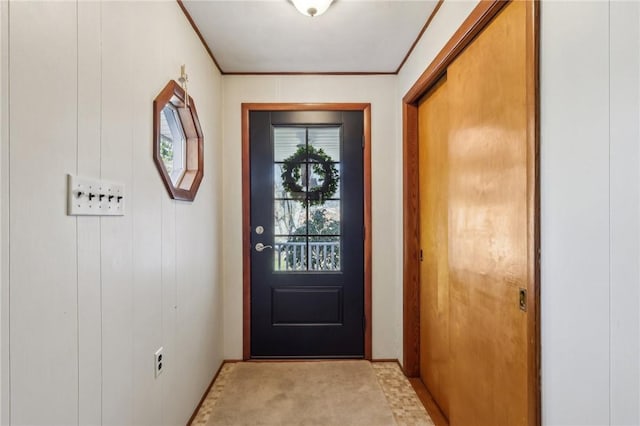 entryway with light colored carpet and crown molding