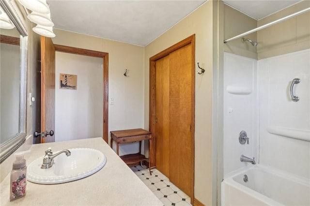 bathroom featuring tile patterned floors, shower / bathing tub combination, and vanity