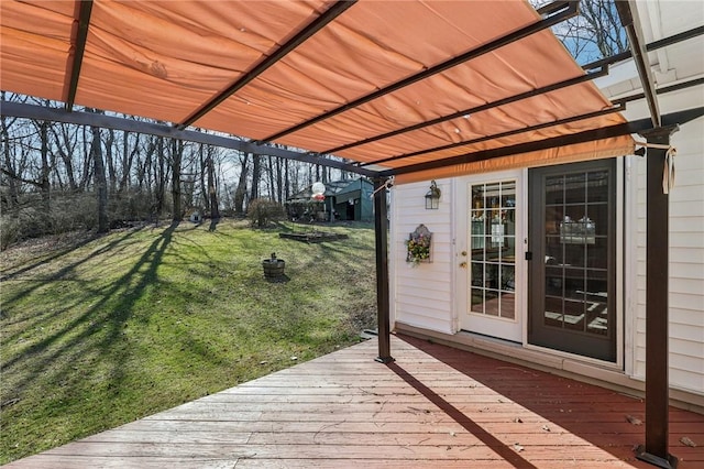 wooden deck featuring a yard and a pergola