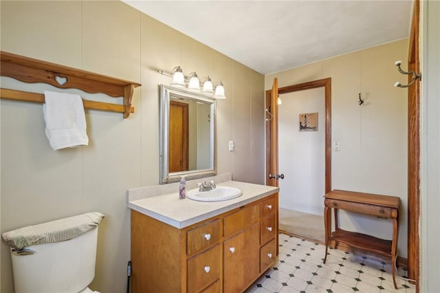 bathroom featuring tile patterned floors, toilet, and vanity