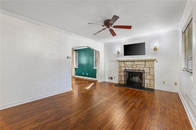 unfurnished living room with ceiling fan, visible vents, hardwood / wood-style floors, and ornamental molding