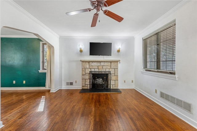 unfurnished living room featuring hardwood / wood-style floors, ornamental molding, visible vents, and ceiling fan