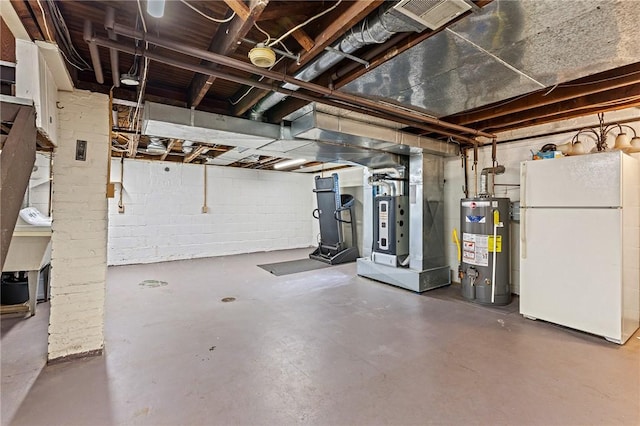 unfinished basement with gas water heater, concrete block wall, and freestanding refrigerator