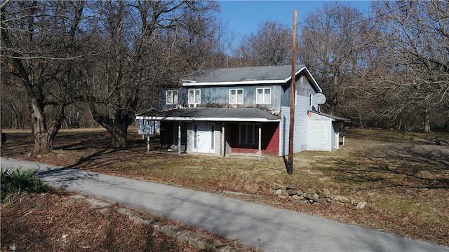 traditional-style home with a front lawn