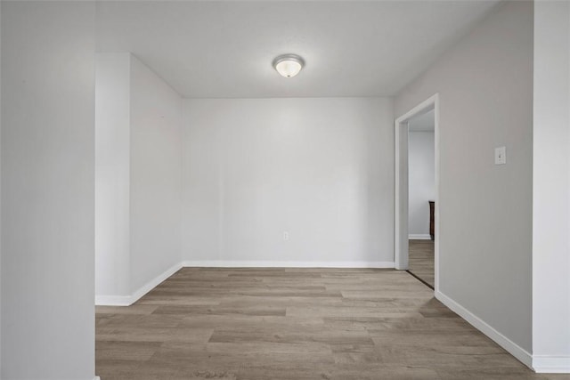 unfurnished room featuring wood finished floors and baseboards