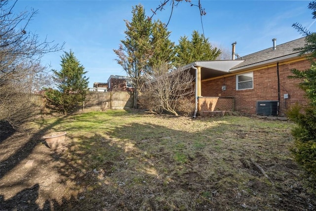 view of yard featuring a fenced backyard and central AC