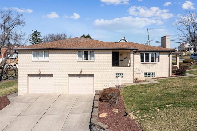 view of front of home with a chimney, concrete driveway, a front lawn, a garage, and brick siding