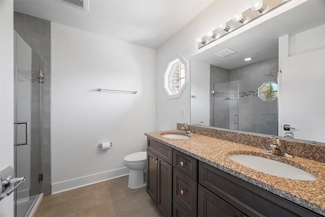 bathroom featuring visible vents, a shower stall, and a sink