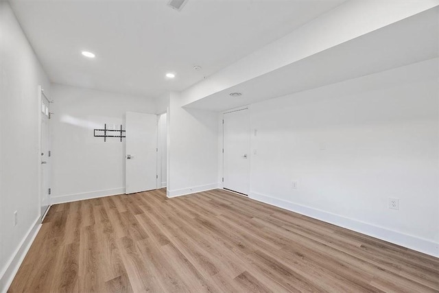 spare room with light wood-style flooring, recessed lighting, and baseboards