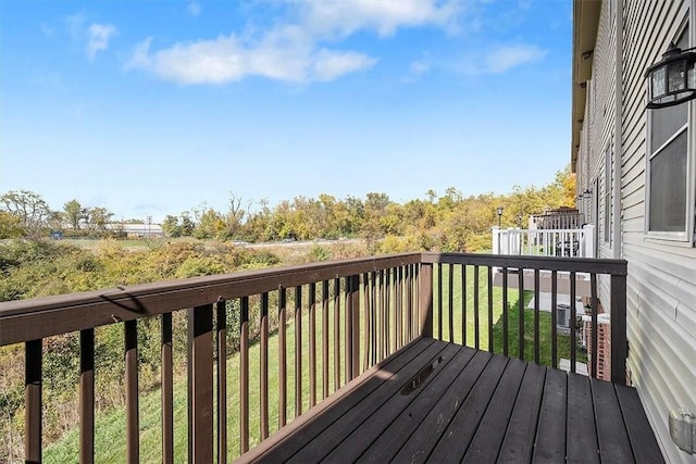 wooden terrace featuring a yard