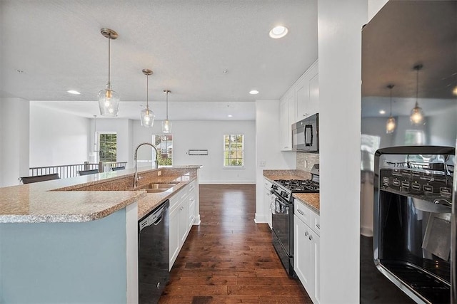 kitchen featuring black appliances, a center island with sink, a sink, white cabinets, and dark wood-style flooring