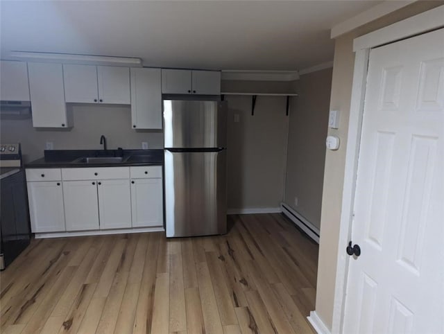 60 Broadhead Ave, Crafton, PA 15205 - kitchen featuring a sink, a baseboard heating unit, under cabinet range hood, dark countertops, and freestanding refrigerator