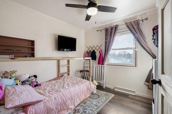 bedroom featuring a ceiling fan, wood finished floors, visible vents, baseboards, and crown molding