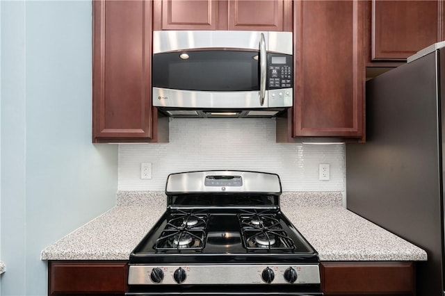 kitchen with decorative backsplash and appliances with stainless steel finishes