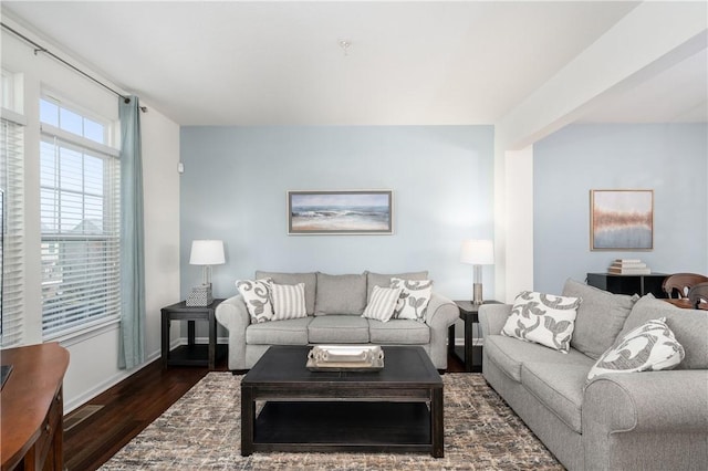 living area with dark wood finished floors and baseboards