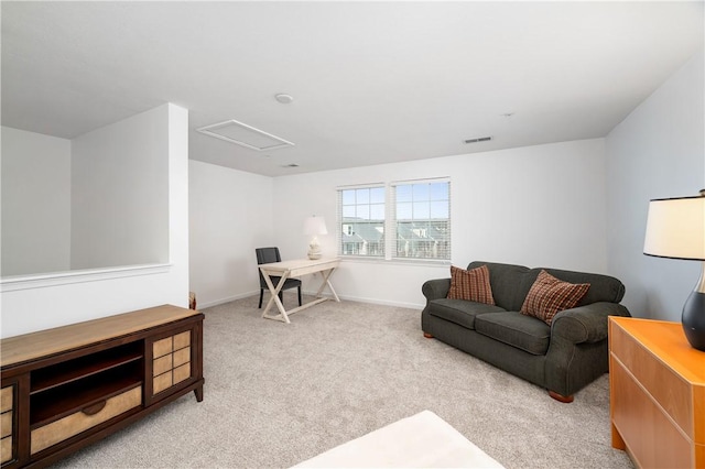 carpeted living area with visible vents, baseboards, and attic access